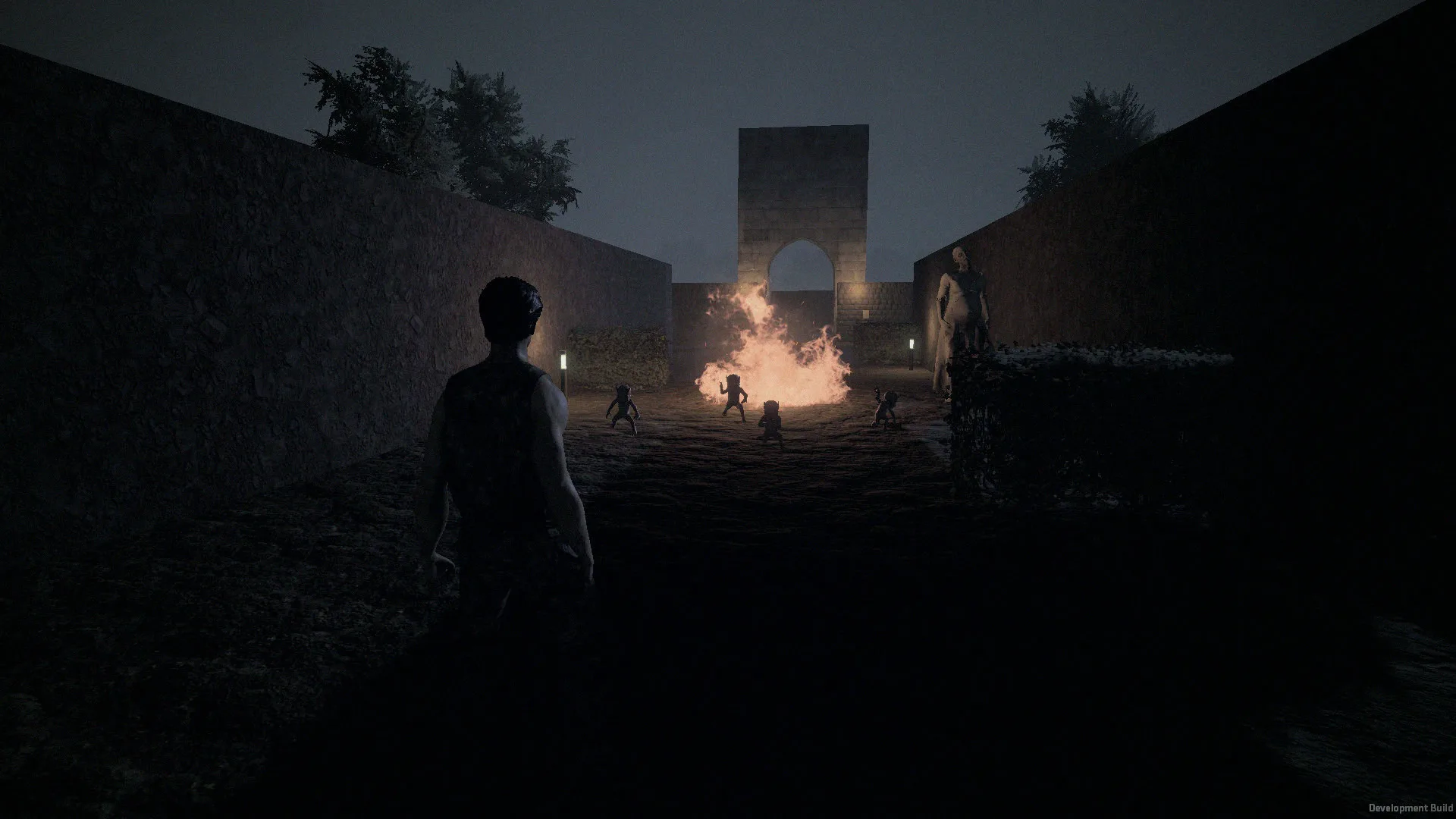 A survivor watches fire burn through a pack of crawlers under the abbey arch